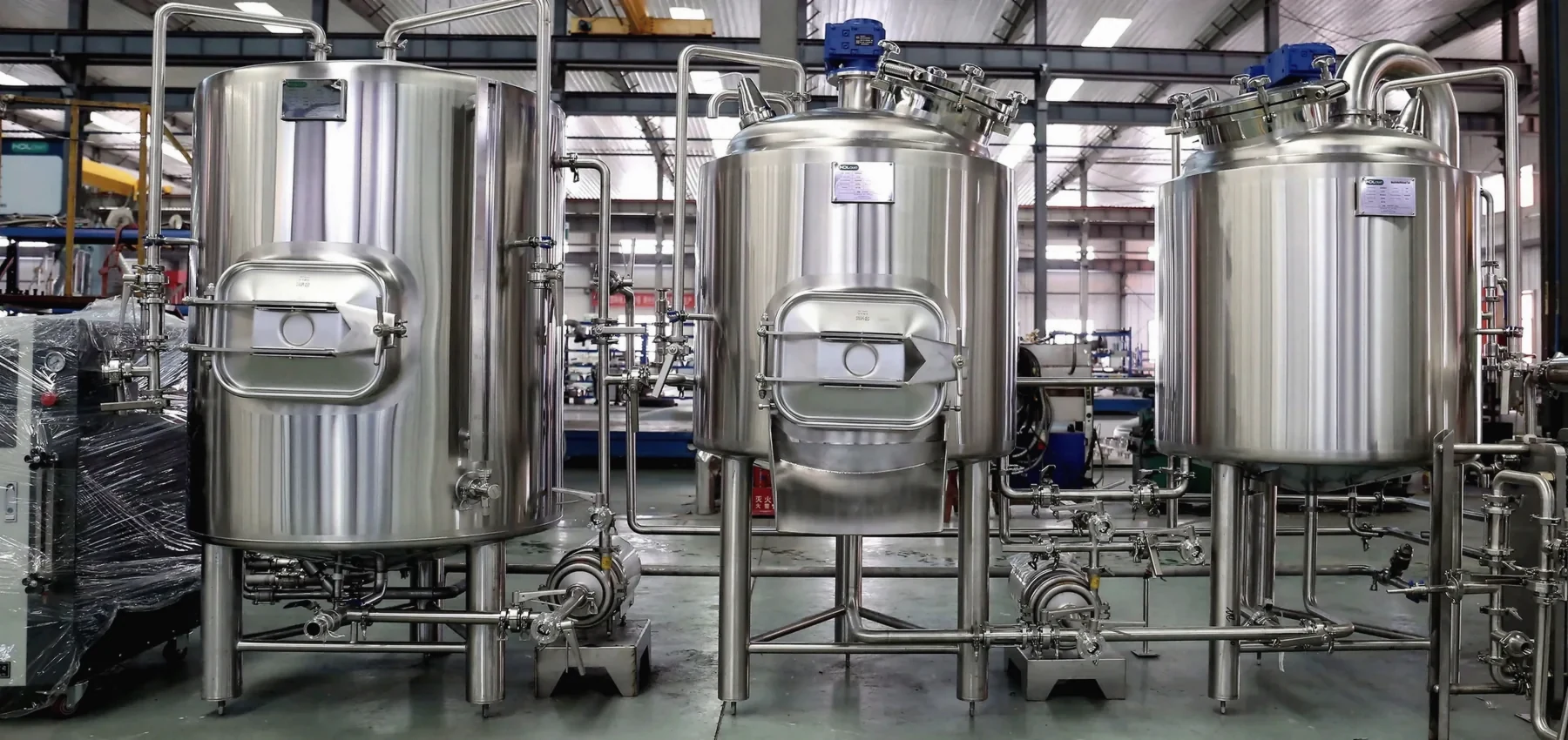 Stainless steel fermentation vessels with sanitary piping.